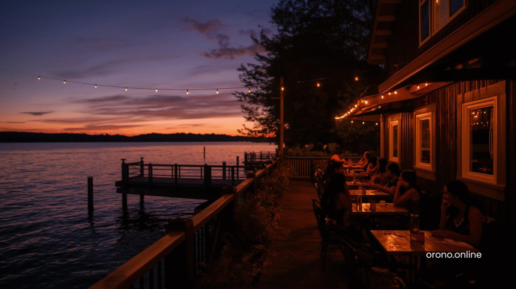 Lake Minnetonka waterfront restaurant at twilight with string lights reflecting on calm water