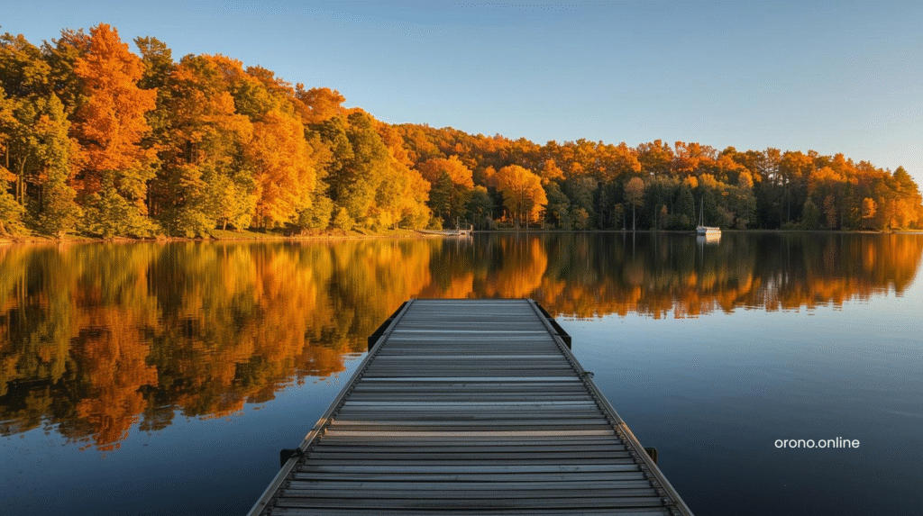 Grays Bay Public Landing boat ramp surrounded by blazing autumn trees reflecting in still Lake Minnetonka water