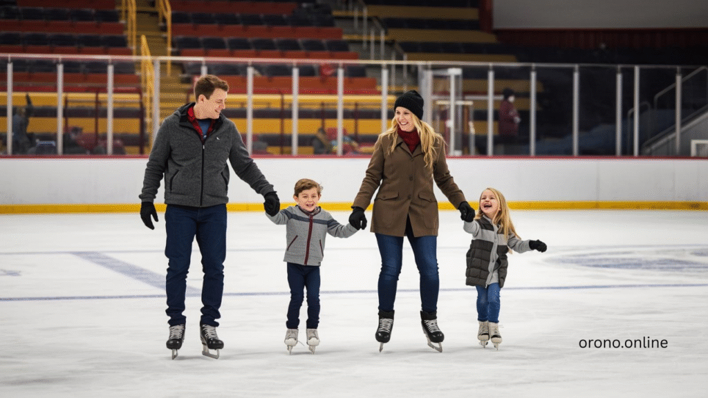 Happy family skating together at Orono Ice Arena public session with parents holding children hands on ice